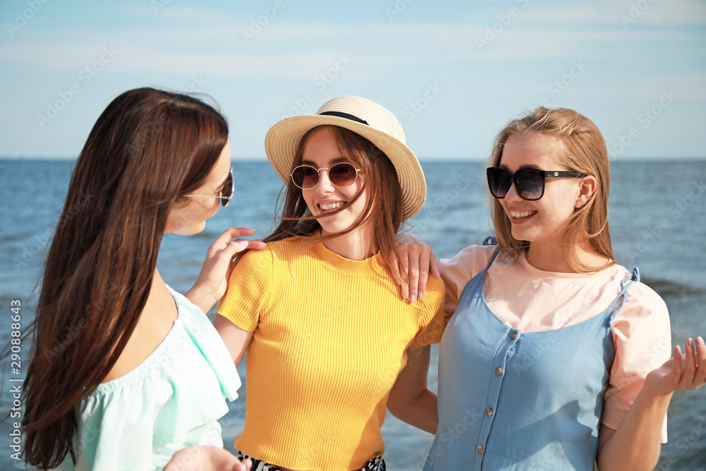 Happy young women on sea beach at resort