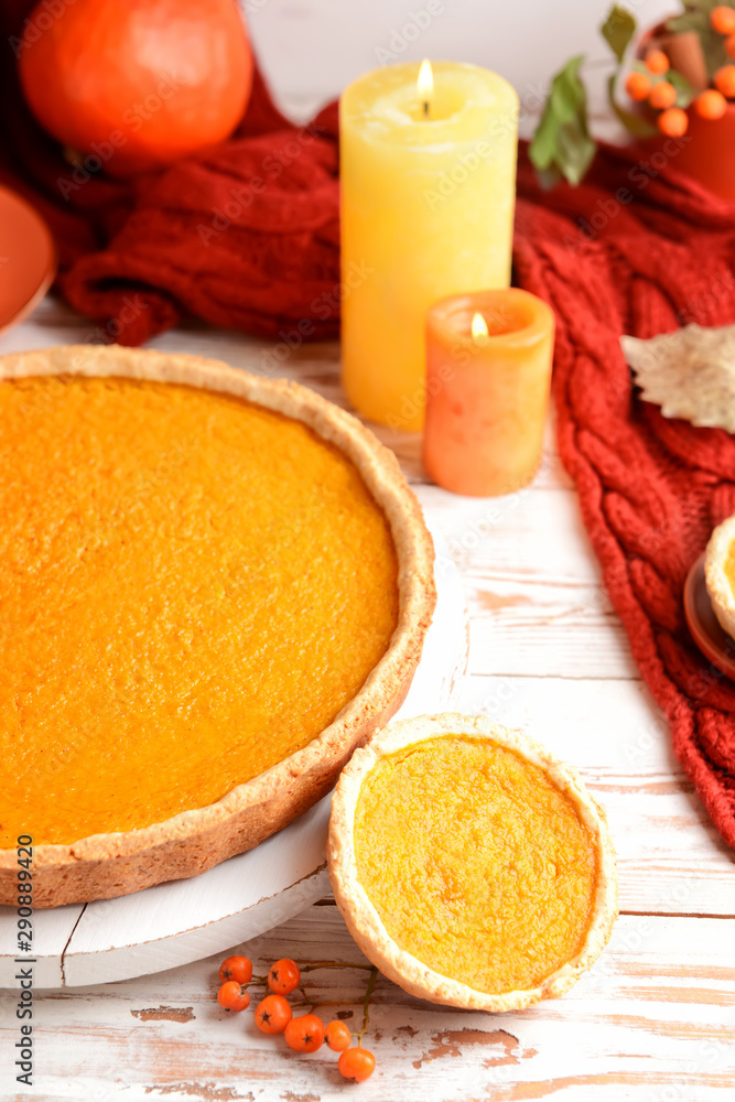 Tasty pumpkin pies on wooden background