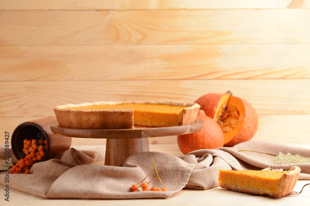 Dessert stand with tasty pumpkin pie on table