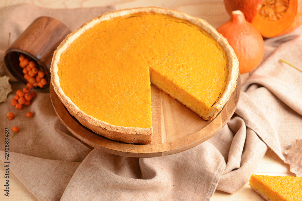 Dessert stand with tasty pumpkin pie on table