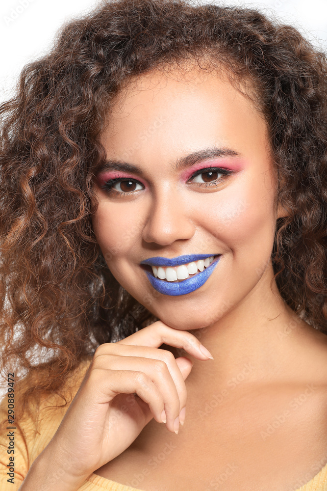 Portrait of fashionable young African-American woman on white background