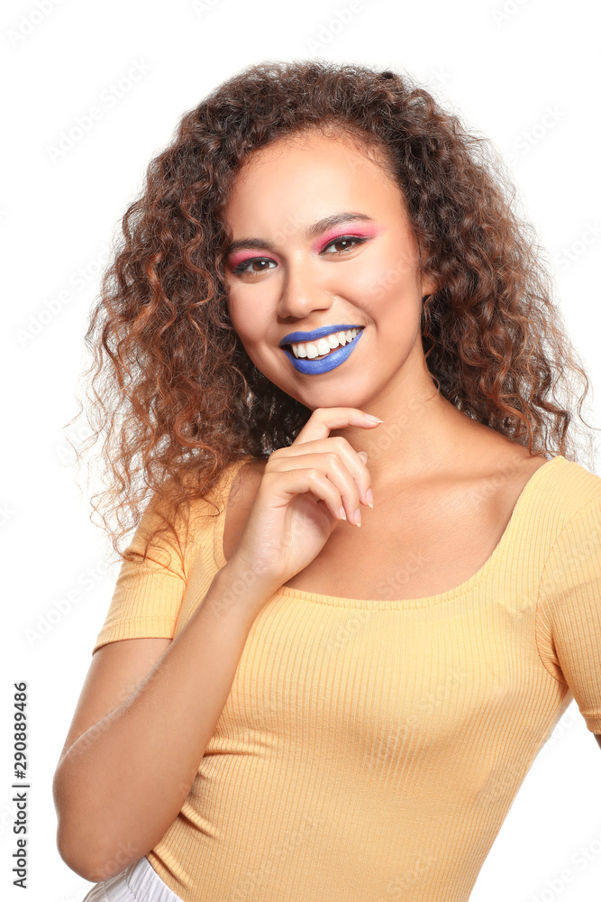 Portrait of fashionable young African-American woman on white background