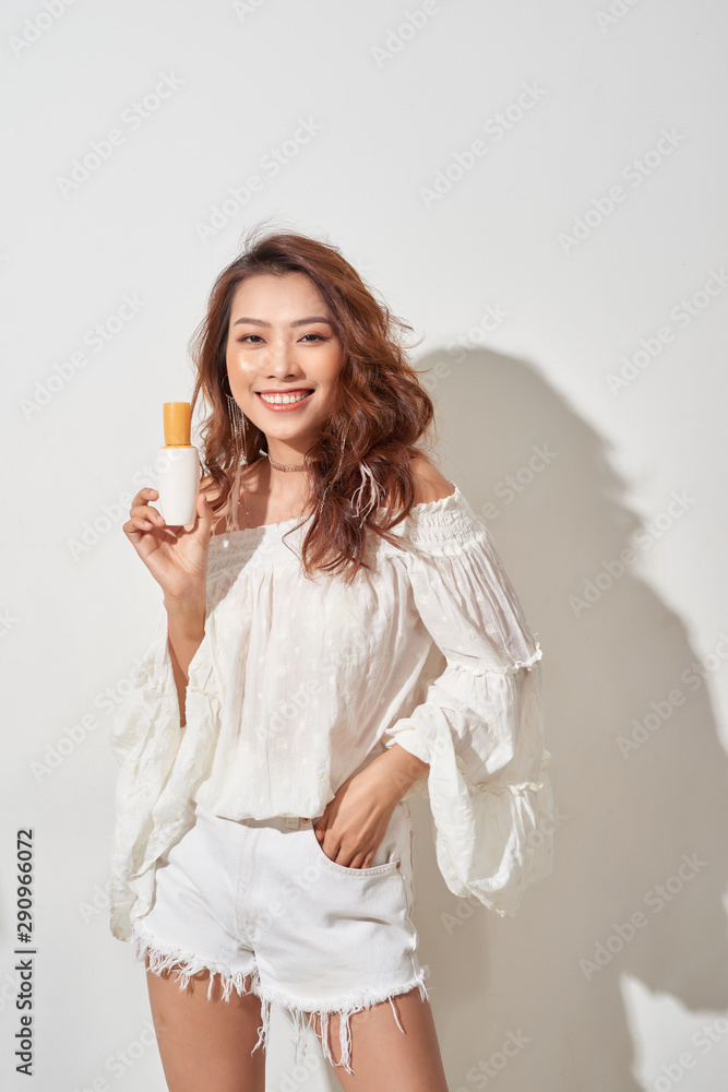 Pretty young woman hold bottle with empty space