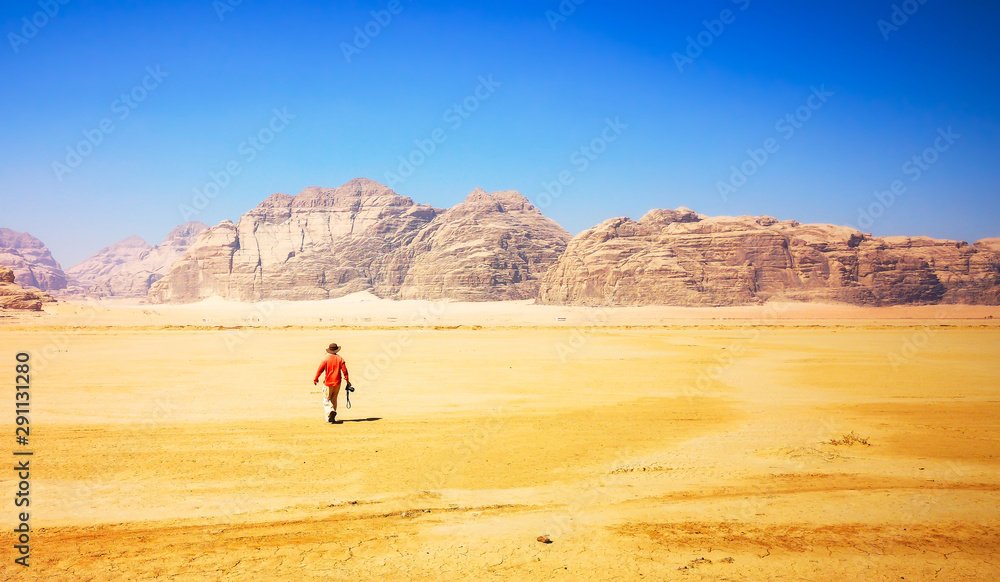 Photographer walking through the desert