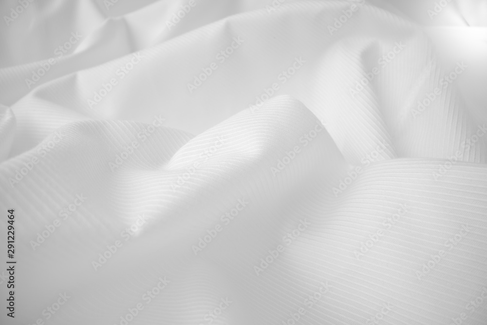 Shiny flowing cloth texture in macro shot. Wavy clean silk weave material. Textile abstract backgrou