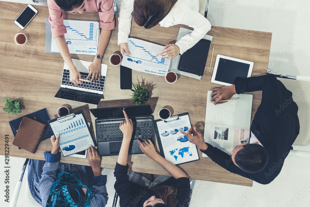 Top view of businessman executive in group meeting with other businessmen and businesswomen in moder