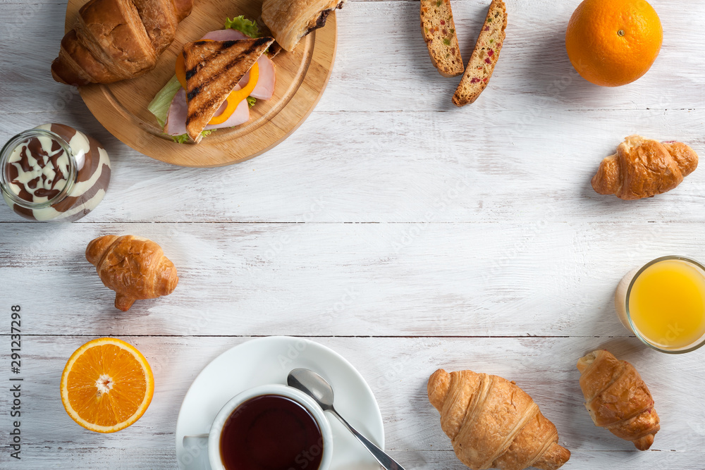 Breakfast with tea, orange juise and croissant