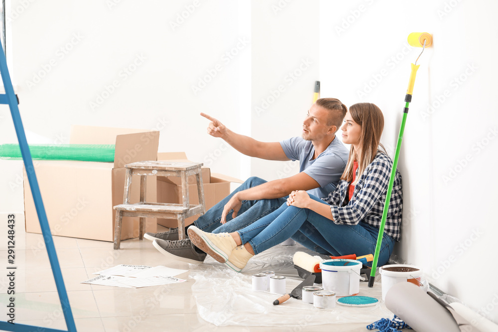 Happy young couple resting during repair of their new house