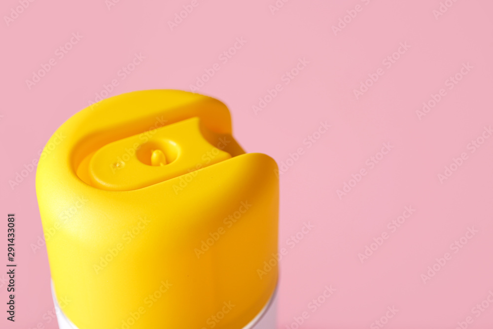 Bottle of air freshener on color background, closeup