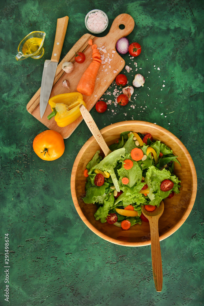 Bowl with tasty vegetable salad on table