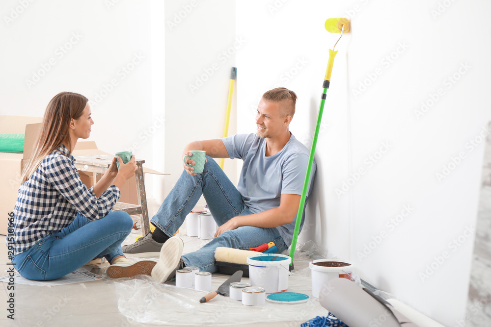 Happy young couple resting during repair of their new house