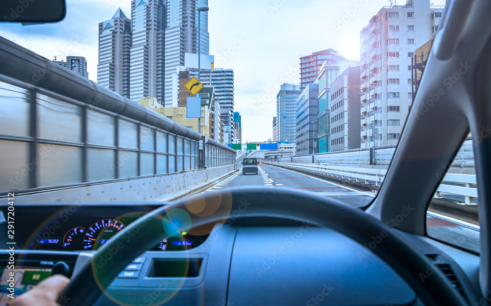 運転席から見る高速道路と都会の景色