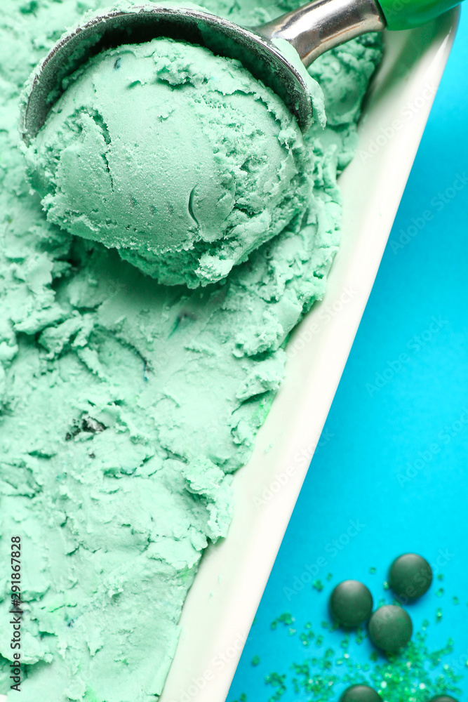 Scoop in bowl with tasty spirulina ice-cream, closeup