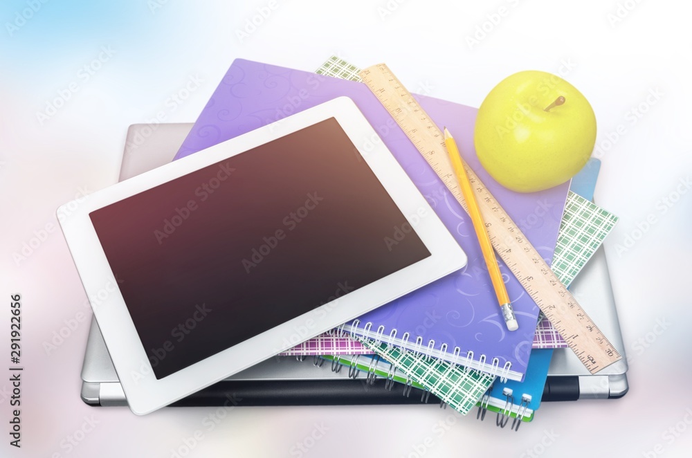 Copybooks,laptop and table pc on  background