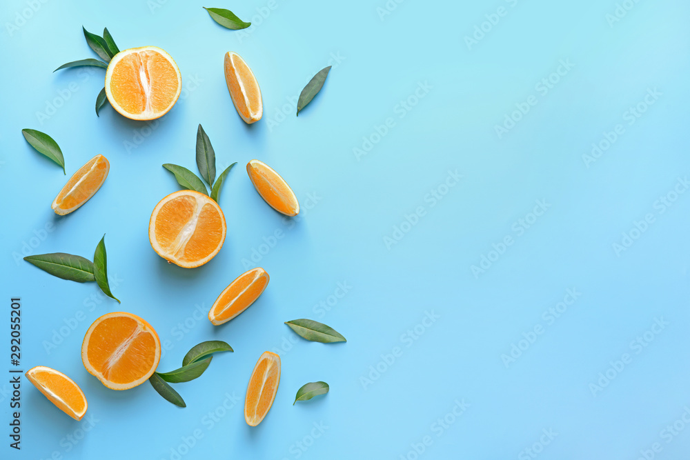 Ripe cut oranges on color background