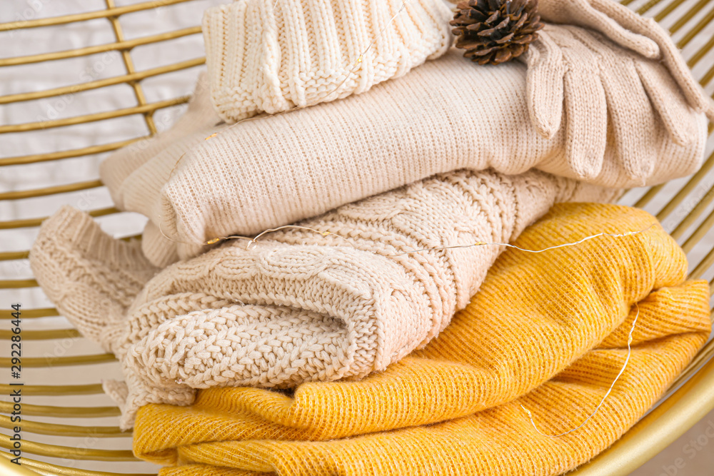 Winter clothes in armchair, closeup