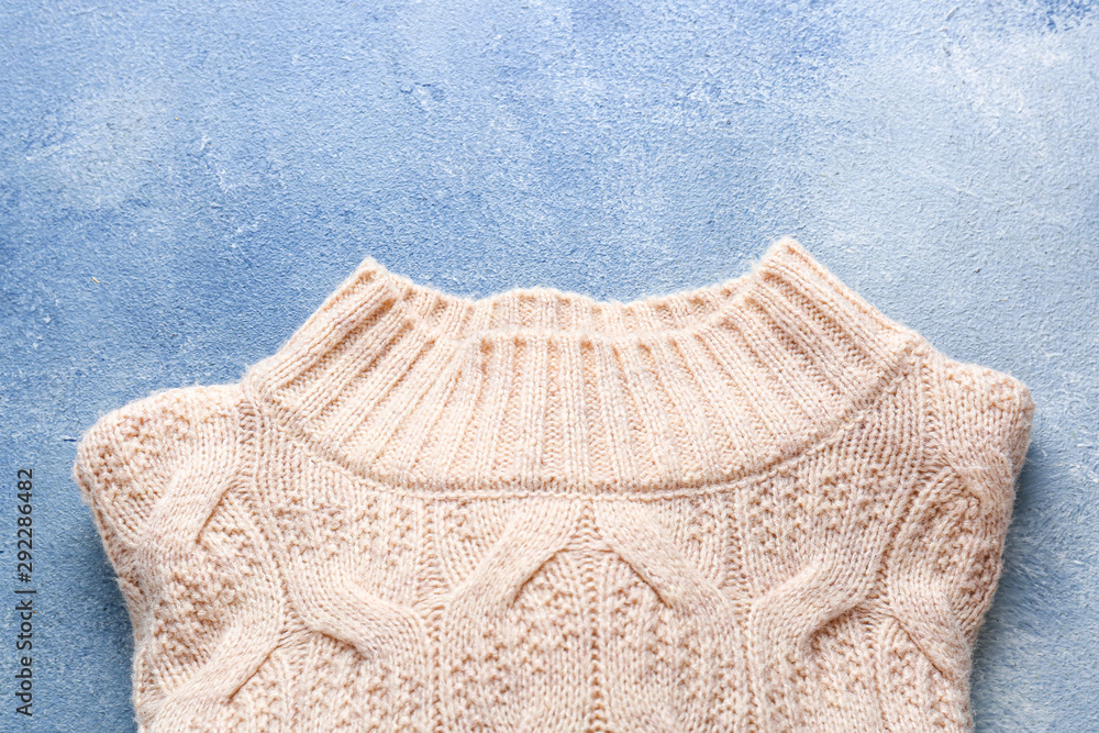 Warm sweater on color background