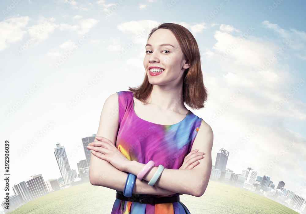 Joyful woman standing with folded arms