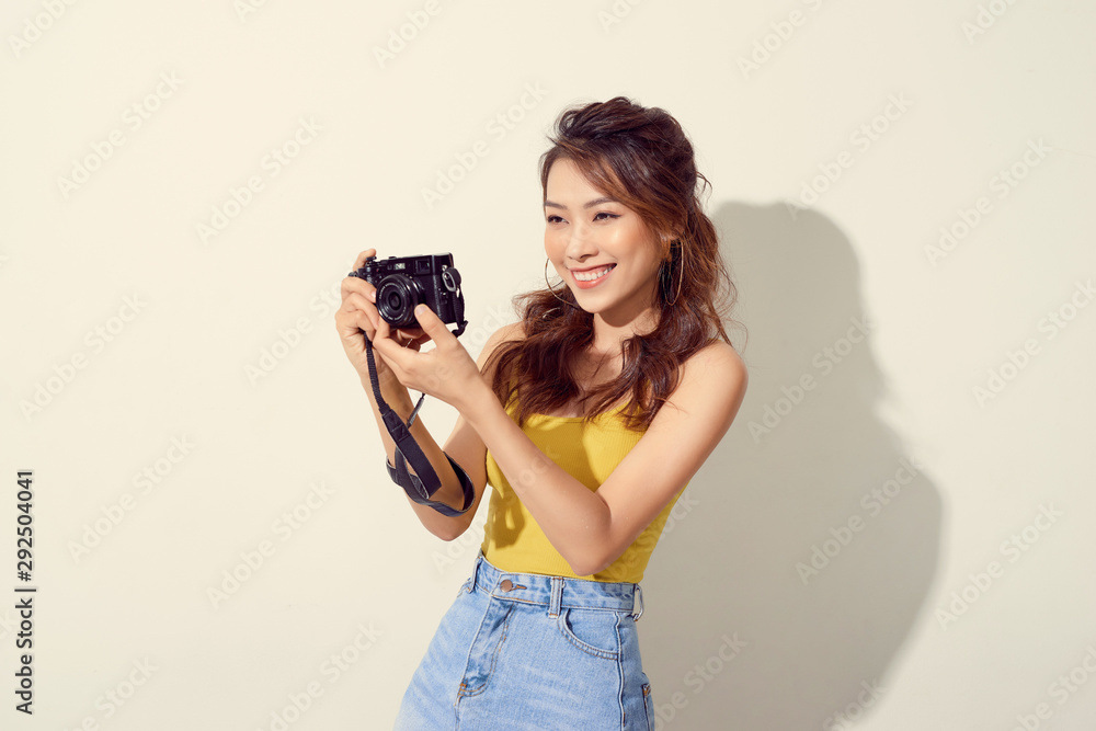 Portrait of fashionable young photographer with  digitalcamera