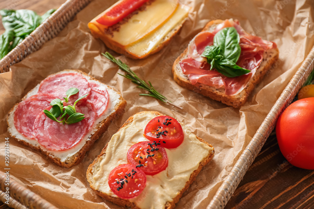 Different tasty sandwiches on tray, closeup