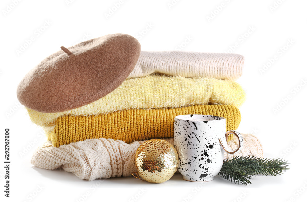 Warm clothes, cup of hot chocolate and Christmas decor on white background