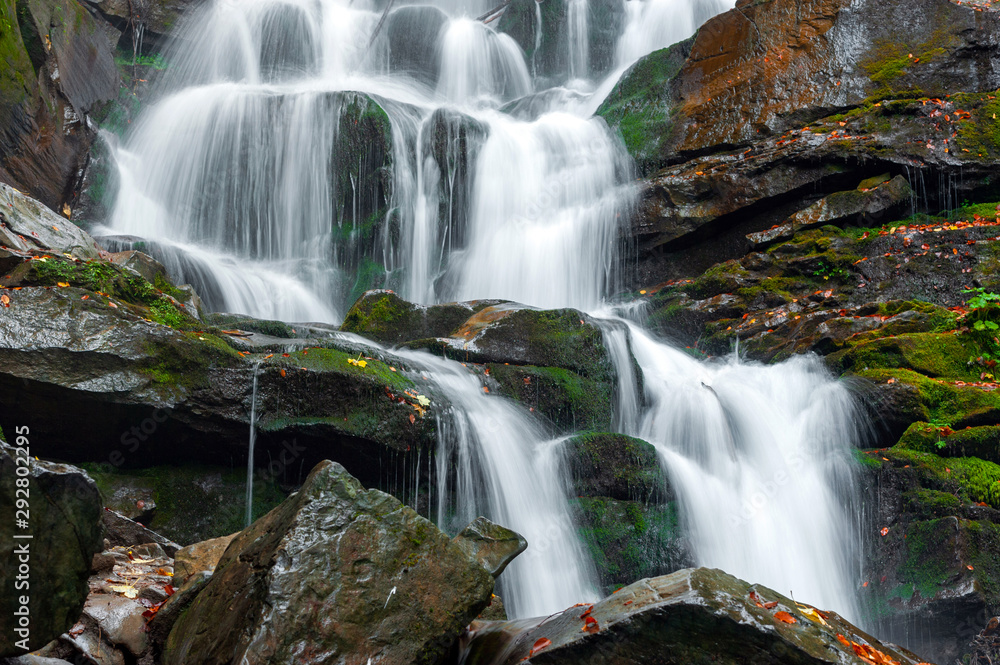 Mountain waterfall in autumn forest