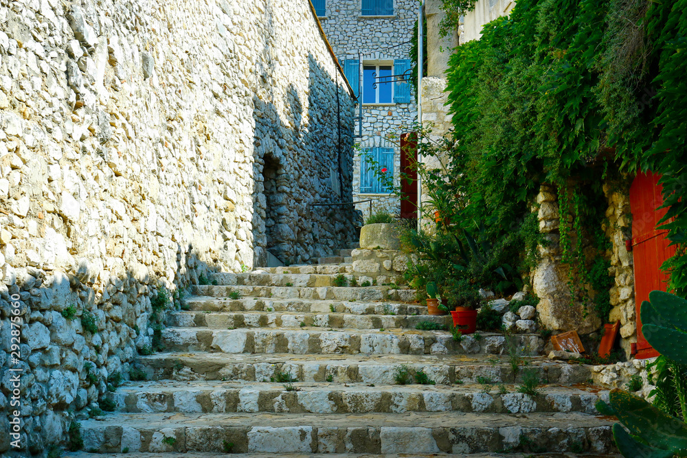 street and stairs of mediterranean village with stone wall