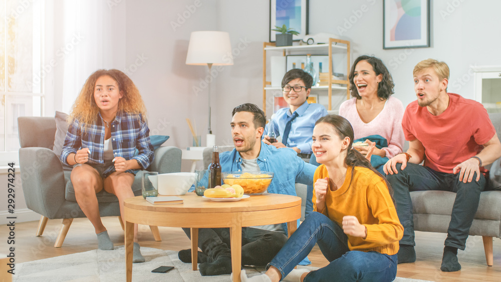 In the Living Room Diverse Group of Friends on Watching Sports Game Match on TV, They Cheer and Chan