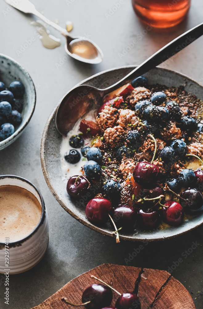 Healthy vegan breakfast set. Quinoa oat granola coconut yogurt bowl with fruit, seeds, nuts, berries