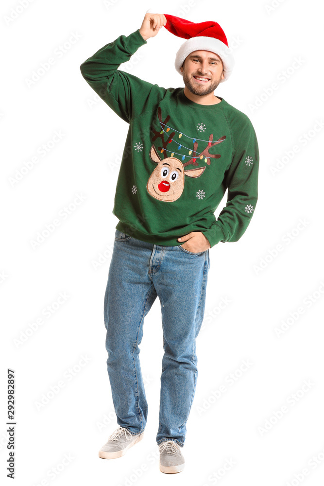 Young man in Christmas sweater and Santa hat on white background