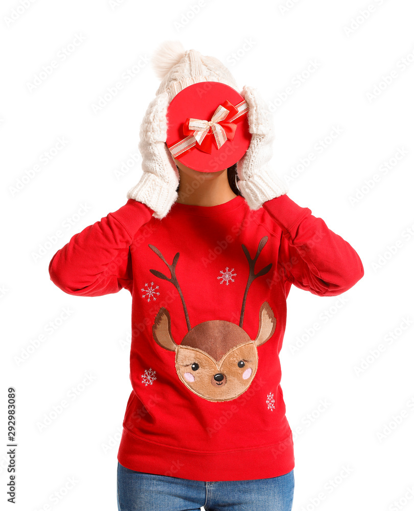 Young woman in Christmas sweater and with gift on white background