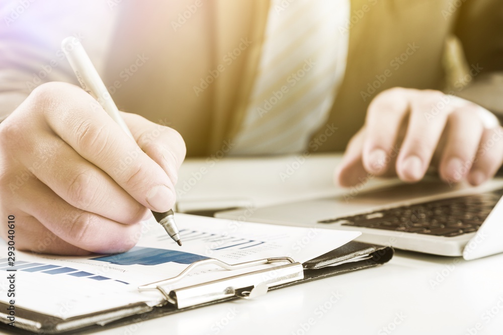 Close-up of Businesswoman makes a note at business document