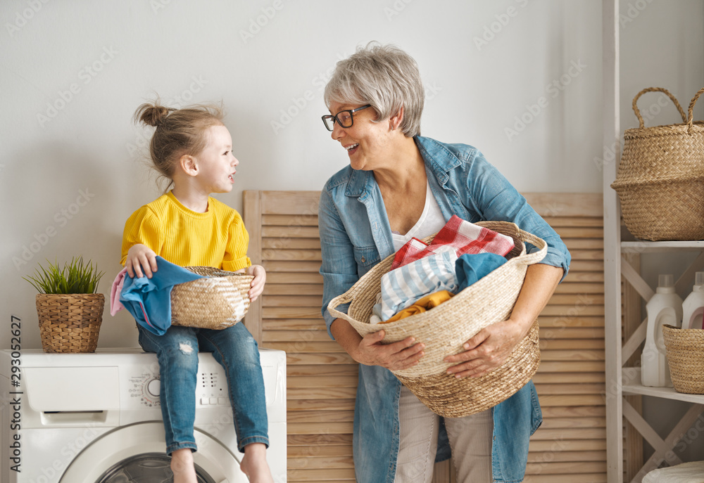 grandma and child are doing laundry