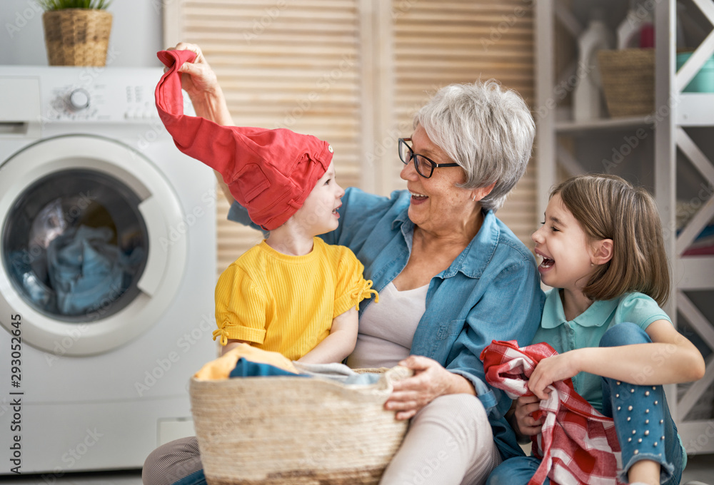 grandma and children are doing laundry