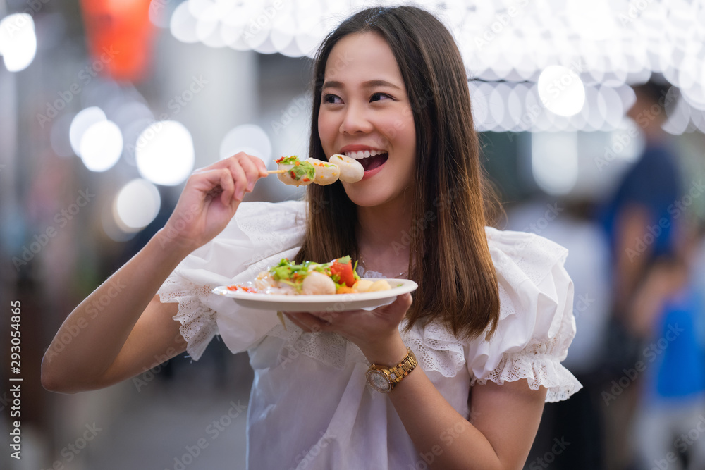 Asian woman tourists eat street food Thailand in the evening