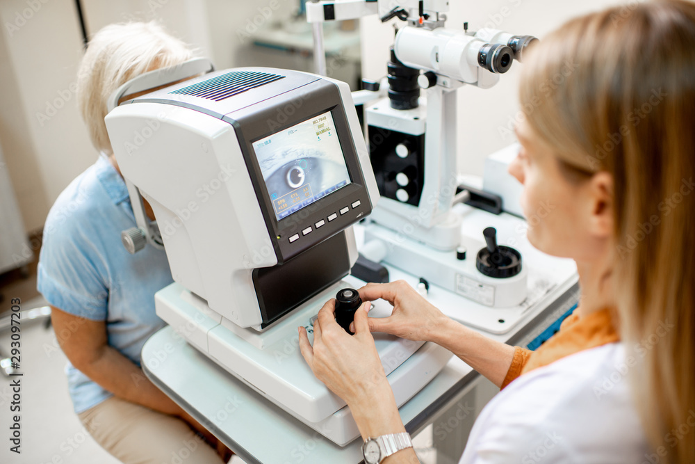 Ophthalmologist examining eyes of a senior patient using digital microscope during a medical examina