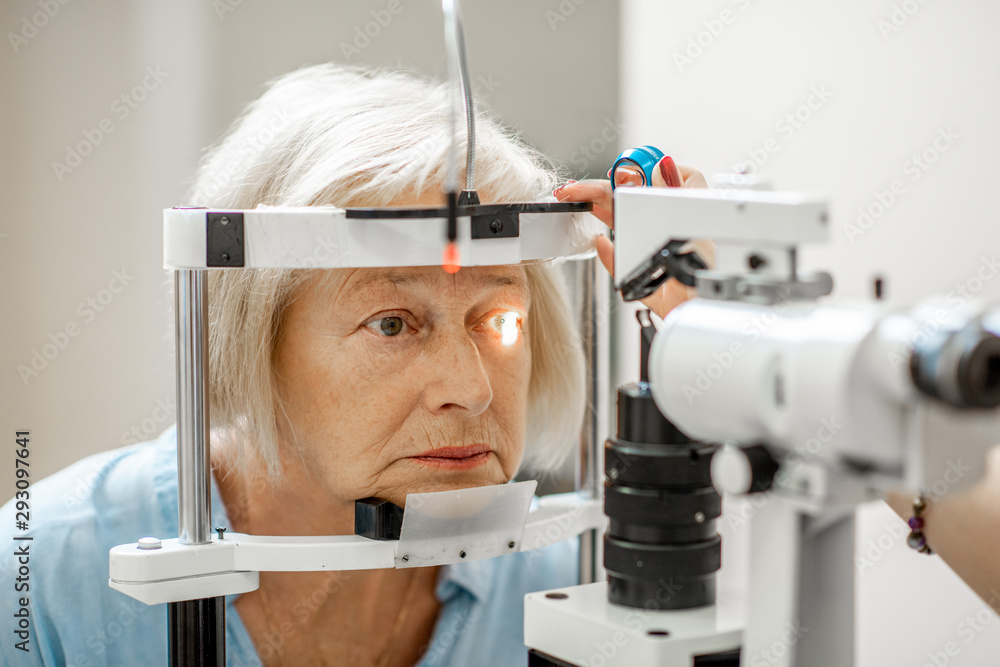 Senior woman during a medical eye examination with microscope in the ophthalmologic office