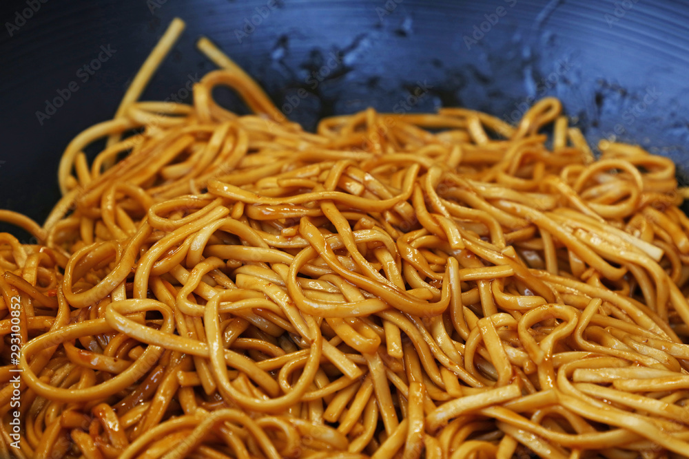 Close up Asian fried noodles in wok pan