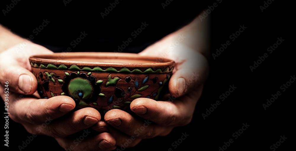 Hands of potter making clay pot, closeup photo