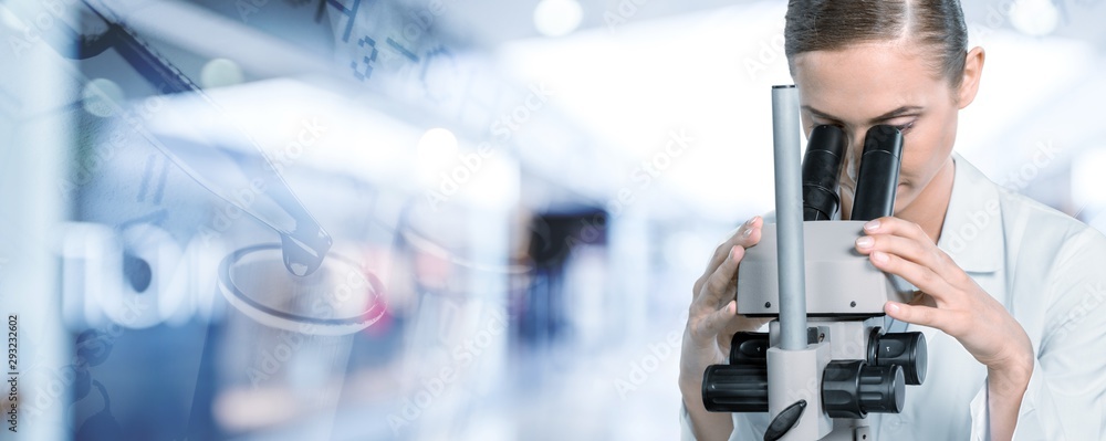 Young female scientist standing  on background