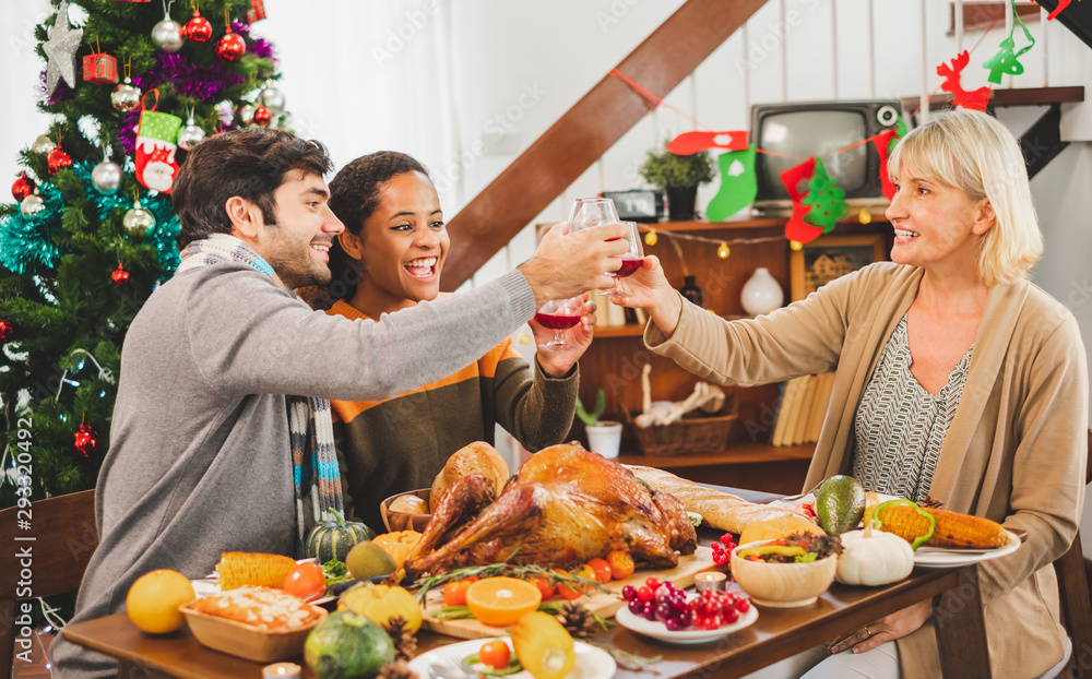 Happy Thanksgiving dinner party with family and food with turkey on table