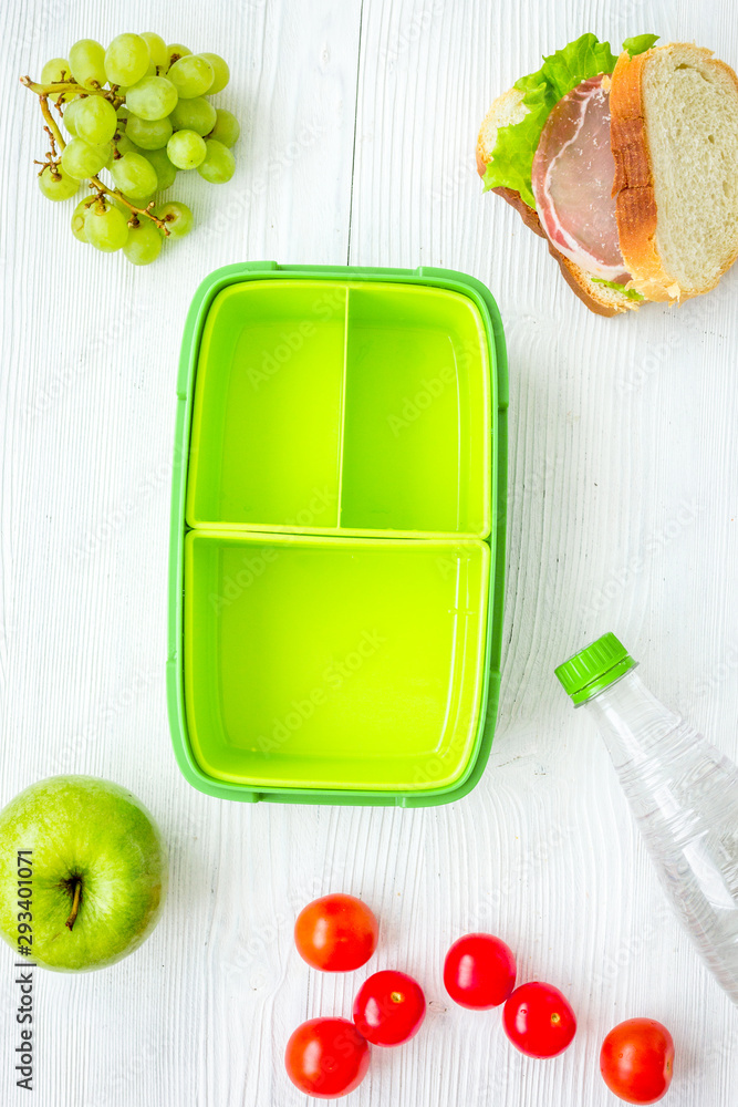 healthy food in lunchbox for dinner at school white table background top view