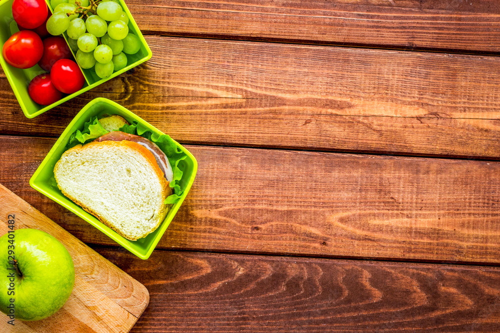 healthy food in lunchbox for dinner at school wooden table background top view mockup