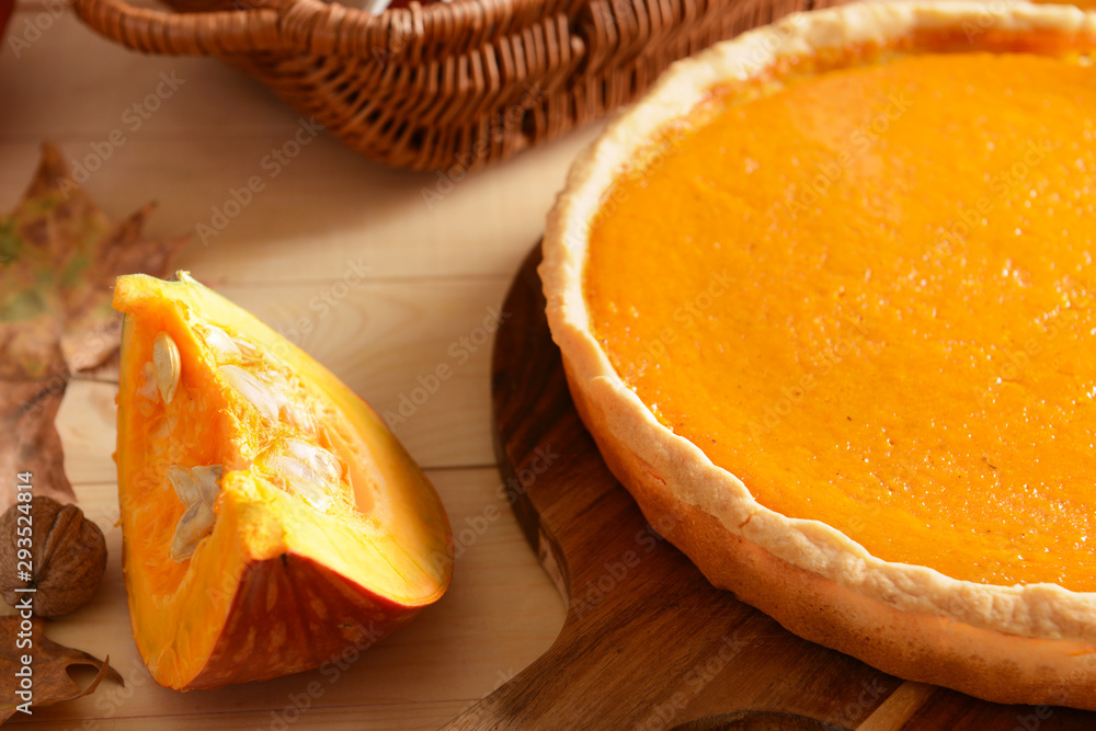 Tasty pumpkin pie on wooden table, closeup