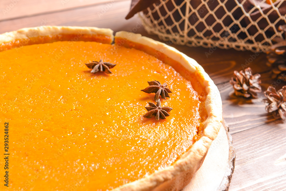 Tasty pumpkin pie on wooden table, closeup