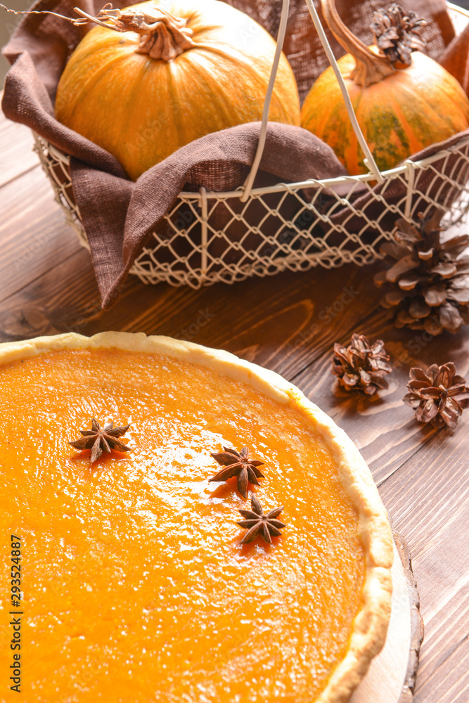 Tasty pumpkin pie on wooden table, closeup