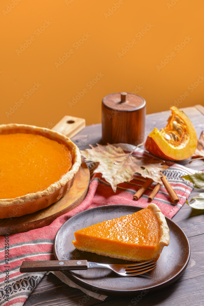 Composition with tasty pumpkin pie on wooden table