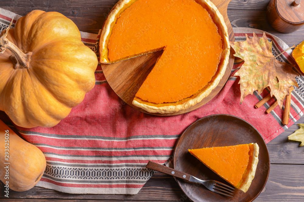 Composition with tasty pumpkin pie on wooden table