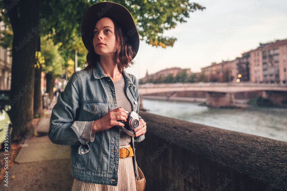 Attractive girl with a camera in Italy