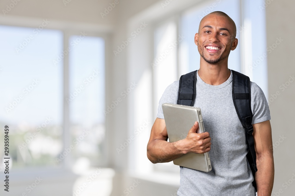 Portrait of smiling young african college student